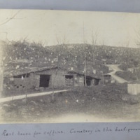 Rest house for coffins. Cemetery in the background